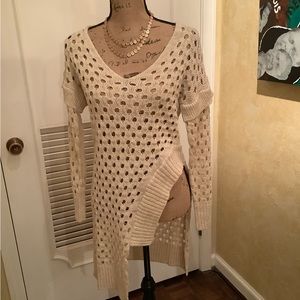 Open knit tunic sweater with hi low profile.